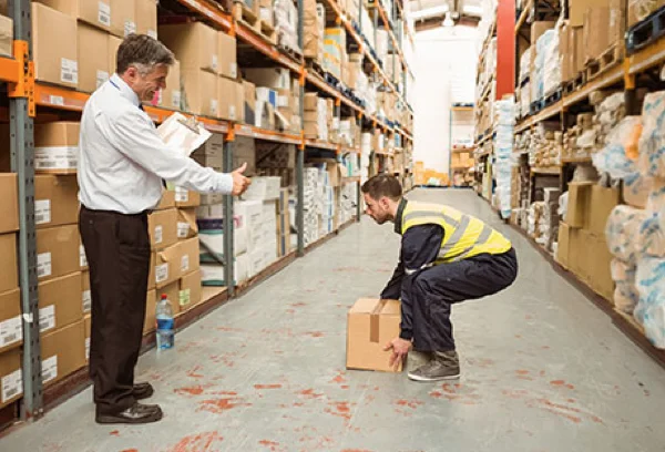 Manual Handling Training Course - Worker demonstrating proper lifting technique in Ireland